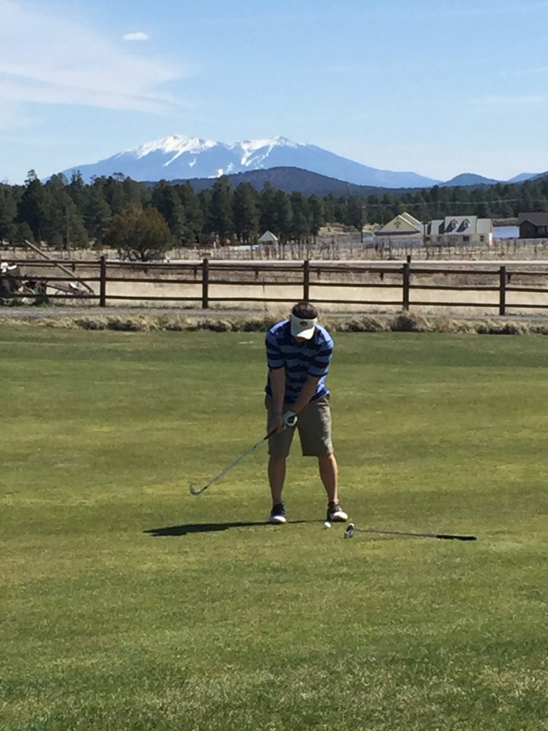 San Fransisco Peaks behind him. Love the snow and we are in shorts.